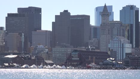 Establishing-skyline-of-Boston-Massachusetts-with-sparkling-waterfront-in-foreground