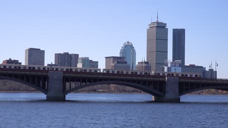 Establishing-city-skyline-of-Boston-Massachusetts-with-Longfellow-bridge-and-subway-train-crossing