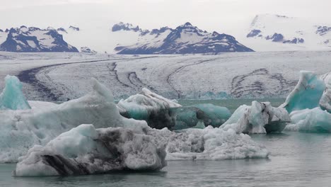 Pan-across-a-vast-melting-glacier-lagoon-at-Jokulsarlon-Iceland