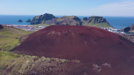 Good-rising-aerial-of-Eldfell-volcano-looming-over-Heimaey-in-the-Westman-Islands-Vestmannaeyjar-Iceland--1