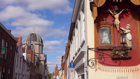 Colorful-adornments-depict-Jesus-along-a-colorful-street-in-Bruges-Belgium