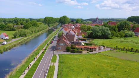 Aerial-over-canal-and-small-town-of-Damme-Belgium-and-historic-windmill