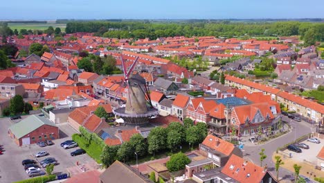 Aerial-over-classic-Dutch-Holland-town-with-prominent-windmill-Sluis-Netherlands