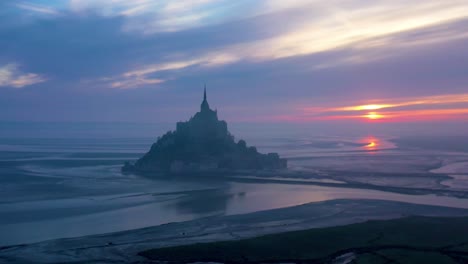 Moody-aerial-of-Mont-Saint-Michel-France-silhouetted-at-sunrise-in-fog