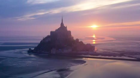Moody-aerial-of-Mont-Saint-Michel-France-silhouetted-at-sunrise-in-fog-2