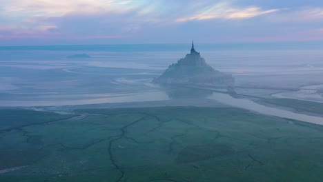 Moody-amazing-aerial-of-Mont-Saint-Michel-France-in-mist-and-fog-in-early-morning