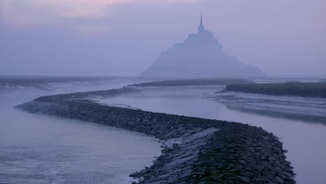 Mont-Saint-Michel-France-rising-out-of-the-mist-and-fog-in-early-morning