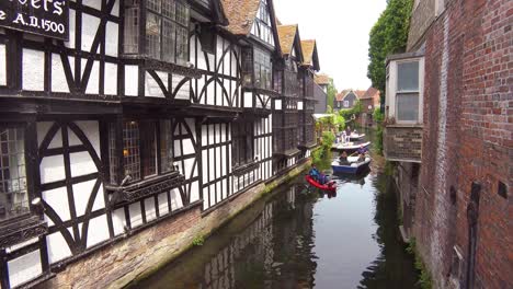 Kayakers-row-under-an-old-bridge-in-the-town-of-Canterbury-United-Kingdom