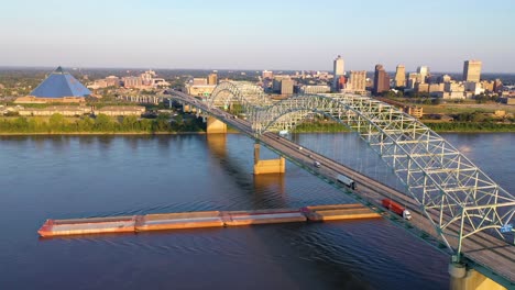 Good-aerial-over-the-Hernando-de-Soto-Bridge-Mississippi-River-and-barge-revealing-Memphis-Tennessee