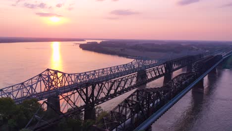 Good-aerial-at-sunset-over-three-bridges-over-the-Mississippi-River-near-Memphis-Tennessee