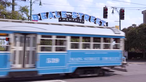 Memphis-trolley-car-on-a-busy-street-outside-Beale-Street-entertainment-district-arch