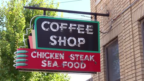 Establishing-of-a-generic-retro-coffee-shop-restaurant-sign-offering-chicken-steak-and-seafood