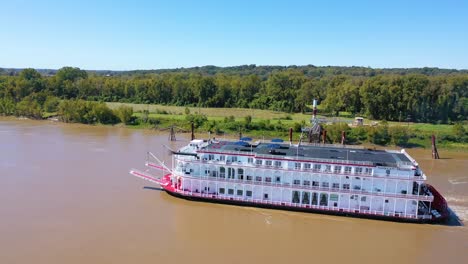 Beautiful-aerial-shot-of-a-paddlewheel-steamboat-luxury-cruise-ship-on-the-Mississippi-River-near-West-Helena-Arkansas