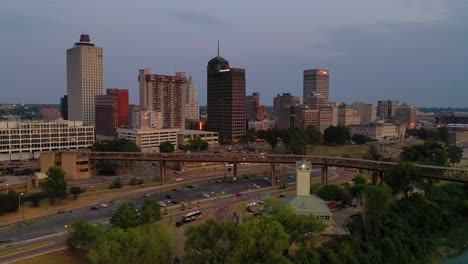 Toma-Aérea-Nocturna-O-Al-Anochecer-Acercándose-Al-Distrito-Comercial-Del-Centro-De-Memphis,-Tennessee