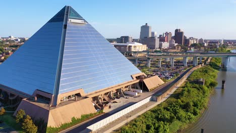 Rising-aerial-shot-of-the-Memphis-pyramid-and-downtown-business-district-of-Memphis-Tennessee-is-background