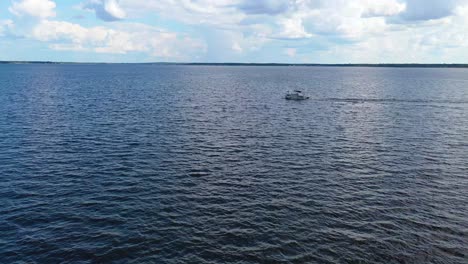 Aerial-of-a-pontoon-pleasure-fishing-boat-traveling-on-Ross-R-Barnett-Reservoir-near-Old-Trace-Park-Jackson-Mississippi-1