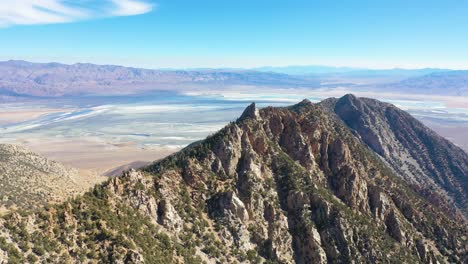 Aerial-over-stone-mountaintop-along-a-ridge-in-the-Eastern-Sierra-mountains-near-Lone-PIne-and-the-Owens-Valley-california