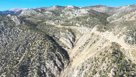 Aerial-over-a-mountain-road-along-a-ridge-in-the-Eastern-Sierra-mountains-near-Lone-PIne-and-the-Owens-Valley-california