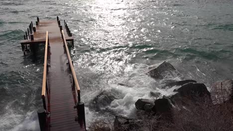 Huge-waves-crash-into-a-pier-and-shore-on-the-banks-of-Lake-Tahoe-during-a-big-winter-storm