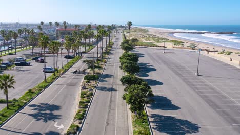 2020---aerial-of-surfers-crossing-abandoned-roads-beaches-of-Ventura-southern-california-during-covid-19-coronavirus-epidemic-as-people-stay-home-en-masse