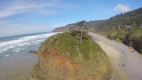 An-aerial-image-rising-up-over-a-beautiful-beach-in-Oregon-with-waves-crashing-1