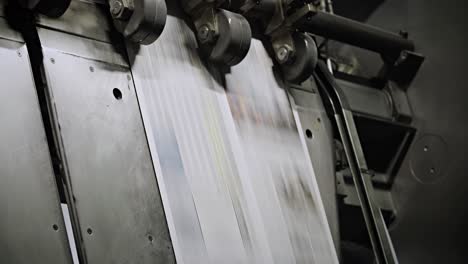 Newspapers-move-along-an-overhead-conveyor-belt-at-a-newspaper-factory-15