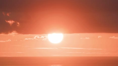 The-sun-sets-in-a-huge-orange-ball-in-time-lapse