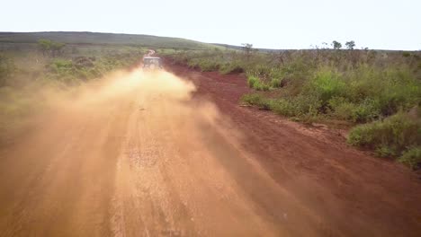 A-silver-Jeep-drives-along-a-red-dirt-road-on-the-island-of-Lanai-in-Hawaii