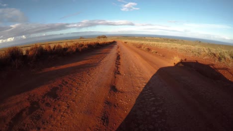 POV-from-the-front-of-a-vehicle-traveling-on-a-very-rutted-dirt-road-on-Molokai-Hawaii-from-Maunaloa-to-Hale-o-Lono-1