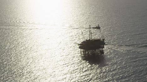 A-beautiful-vista-aérea-shot-over-a-boat-heading-out-to-oil-derricks-and-platforms-in-the-Santa-Barbara-Channel-California-1