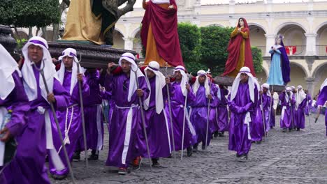 Robed-priests-carry-giant-statues-in-a-colorful-Christian-Pascua-celebration-in-Antigua-Guatemala