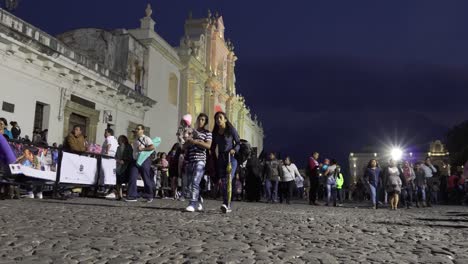 Pov-Aufnahme-Von-Menschen,-Die-Nachts-Entlang-Einer-Belebten-Straße-Vor-Der-Kathedrale-In-Antigua-Guatemala-Gehen?