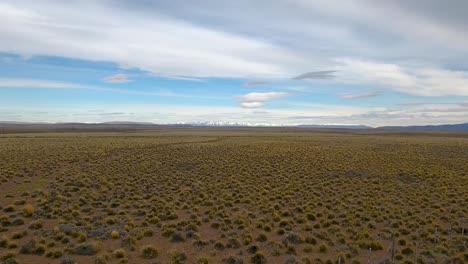 Beautiful-aerial-of-vast-patagonia-landscape-and-Andes-mountains-near-Bolson-Argentina