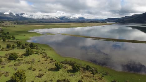 Beautiful-aerial-of-Andes-mountains-a-lake-and-pasture-land-near-Los-Alerces-National-Park-2
