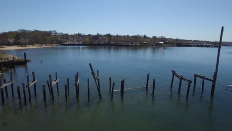 An-aerial-over-wooden-stakes-in-a-lake