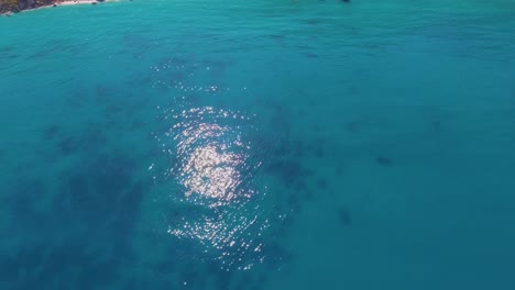 Aerial-over-beautiful-blue-Mediterranean-ocean-waters-reveals-Greek-Island-of-Lefkada