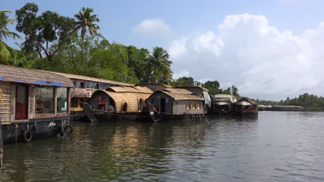 Tourists-houseboats-line-a-river-in-Kerala-India