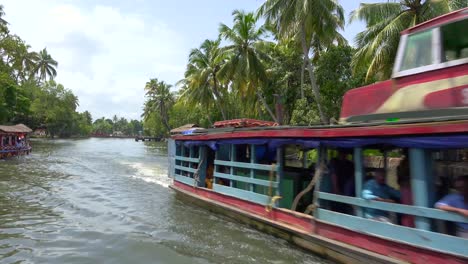 Houseboats-and-activities-along-the-river-in-the-backwaters-of-Kerala-India-1
