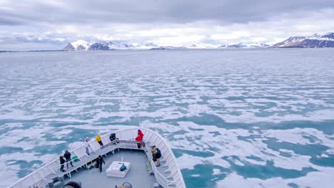 A-POV-time-lapse-shot-of-a-ship-bow-icebergs-and-tourists-passing-through-Bellsund-Bay-or-fjord-in-Norway