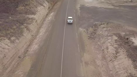 Good-aerial-above-a-pickup-truck-driving-on-a-coastal-road-in-Somalia-or-Djibouti