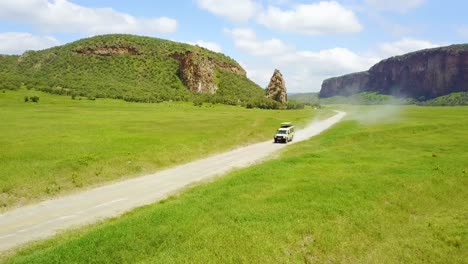 Aerial-of-a-4-WD-safari-jeep-driving-in-Hell's-Gate-National-park-Rift-Valley-Kenya-Africa