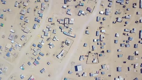 Aerial-over-a-strange-abandoned-town-of-empty-lonely-suburban-tract-houses-in-the-desert-of-Namibia-Africa-4