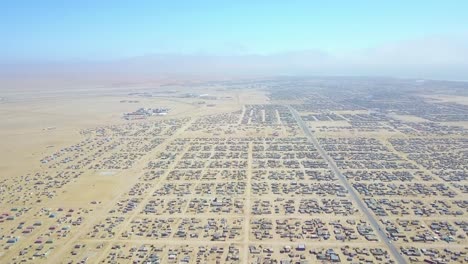 Aerial-over-a-strange-abandoned-town-of-empty-lonely-suburban-tract-houses-in-the-desert-of-Namibia-Africa-5