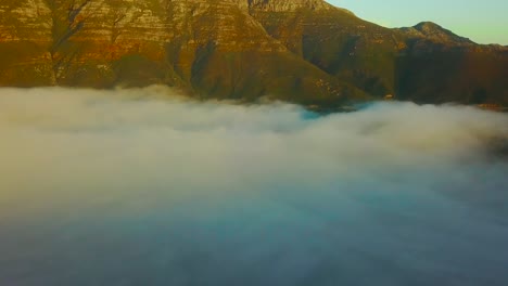 Drone-aerial-above-the-clouds-looking-at-Table-Mountain-and-Twelve-Apostles-behind-Cape-Town-South-Africa-2
