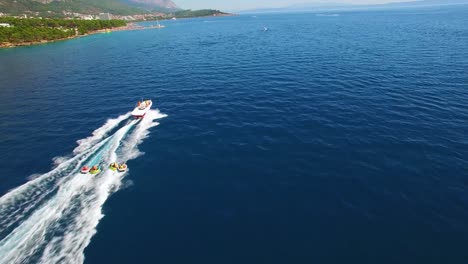 Aerial-of-adventure-boat-towing-four-innertubes-for-a-tubing-adventure-off-the-coast-of-Croatia-1