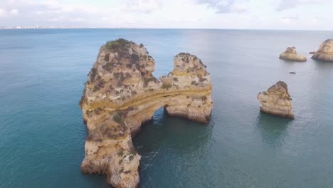 Aerial-of-Lagos-beach-rock-formations-ocean-and-coastline-in-Portugal