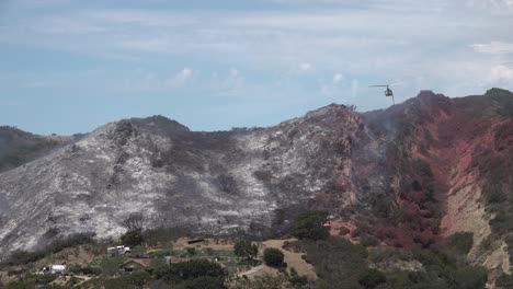 Helicopter-Water-Drop-And-Firefighters-Mop-Up-After-A-Brush-Fire-Burns-A-Hillside-Near-Hollister-Ranch-In-Santa-Barbara-California