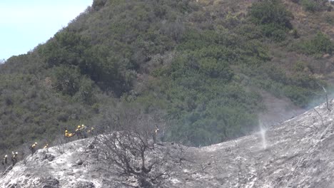 Helicopter-Water-Drop-And-Firefighters-Mop-Up-After-A-Brush-Fire-Burns-A-Hillside-Near-Hollister-Ranch-In-Santa-Barbara-California-4