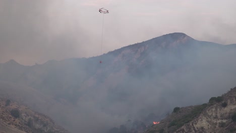 A-Helicopter-Makes-A-Water-Drop-On-A-Brush-Fire-In-The-Hills-Of-Southern-California-1