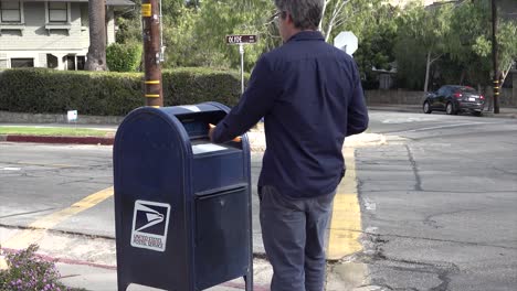 A-Man-Walks-To-A-Mailbox-And-Mails-A-Homemade-Voter-Registration-Card-Encouraging-People-To-Vote-In-The-Election